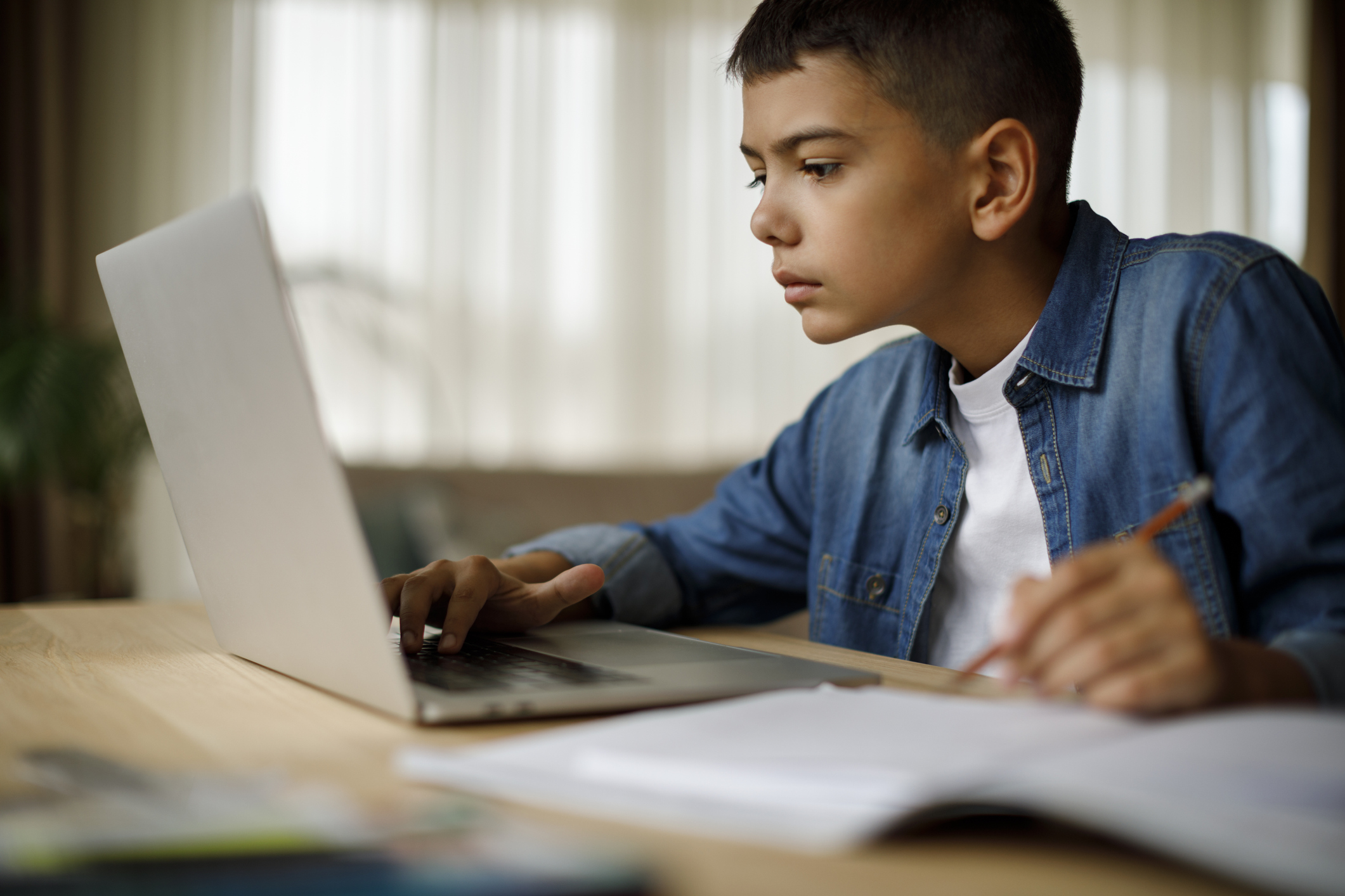 Teenage boy using laptop for homework