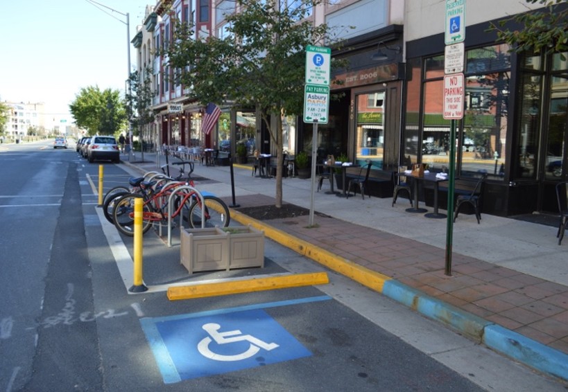 A bike corral near a crosswalk in Asbury Park, NJ uses low-cost materials, such as flex-posts and temporary curbs, to restrict illegal parking within 25 feet of the crosswalk, increasing visibility for vehicles and people crossing. (Source: NJDOT Bicycle & Pedestrian Resource Center)